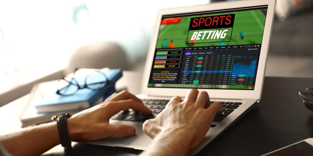 Man,Betting,On,Sports,Using,Laptop,At,Table,,Closeup.,Bookmaker Sports betting on a laptop