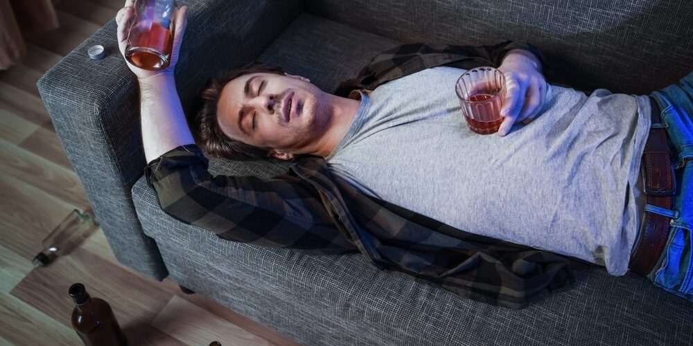 Depressed,Man,Suffering,From,Alcoholism,And,Addiction,Lies,Passed,Out stages of alcoholism