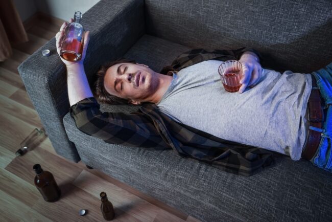 Depressed,Man,Suffering,From,Alcoholism,And,Addiction,Lies,Passed,Out stages of alcoholism